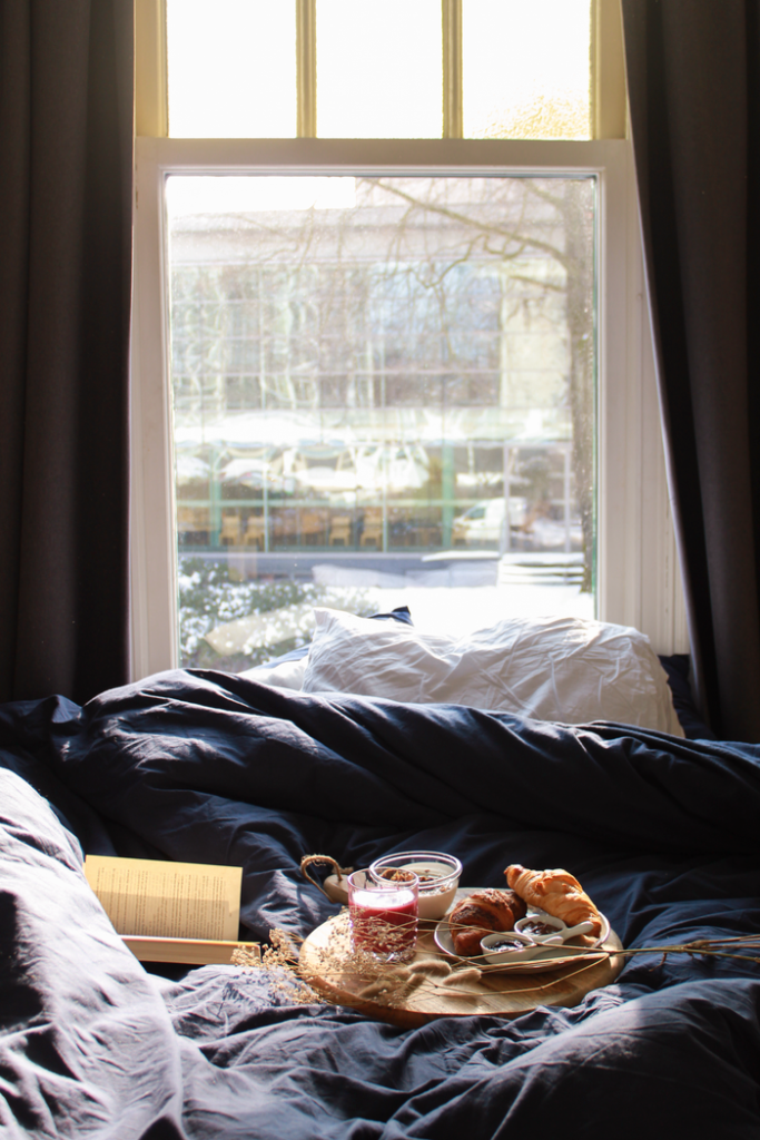 Relaxing morning scene with croissants on a tray by a window, perfect for a cozy lifestyle.